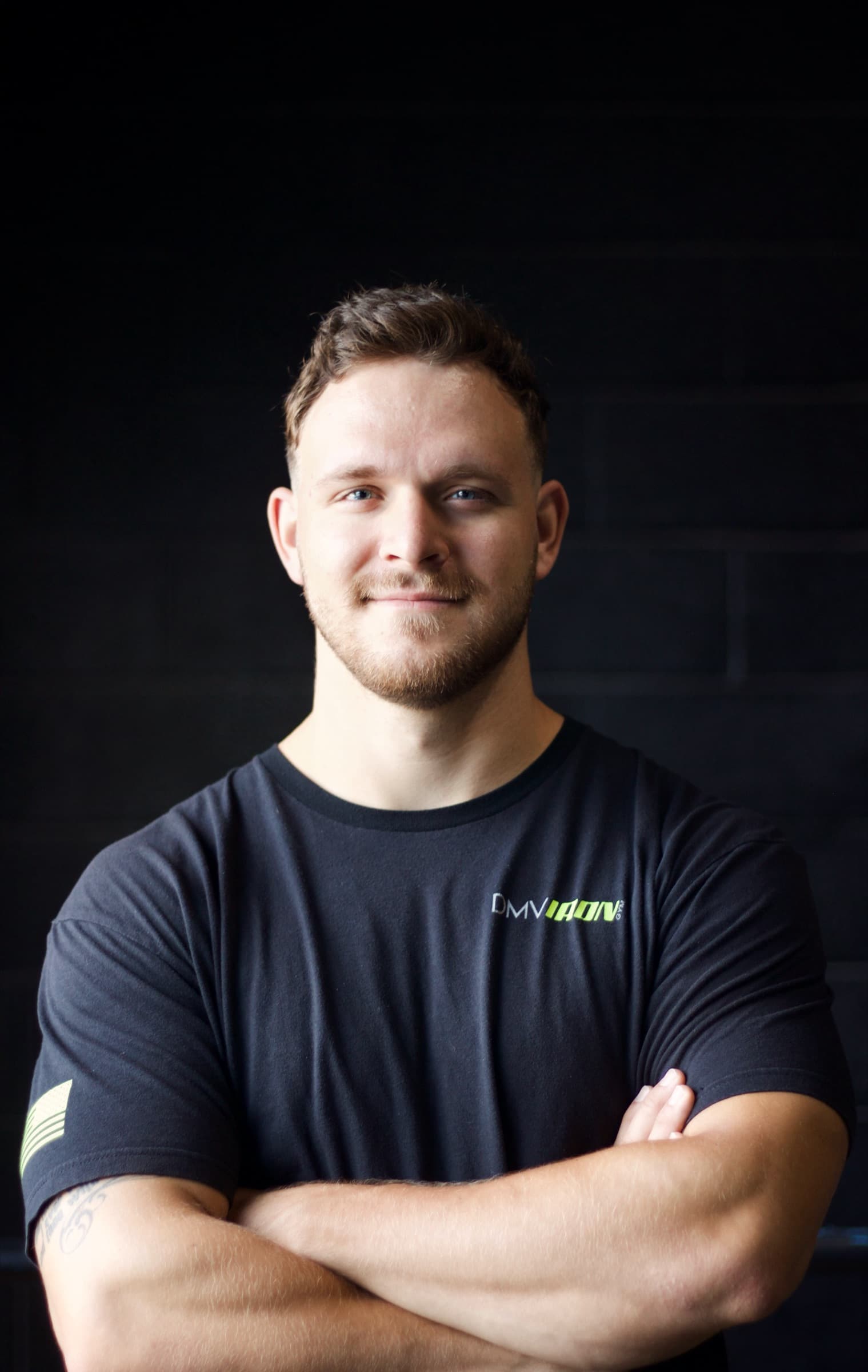 Phil Lackey, personal trainer in Arlington VA, standing with arms crossed